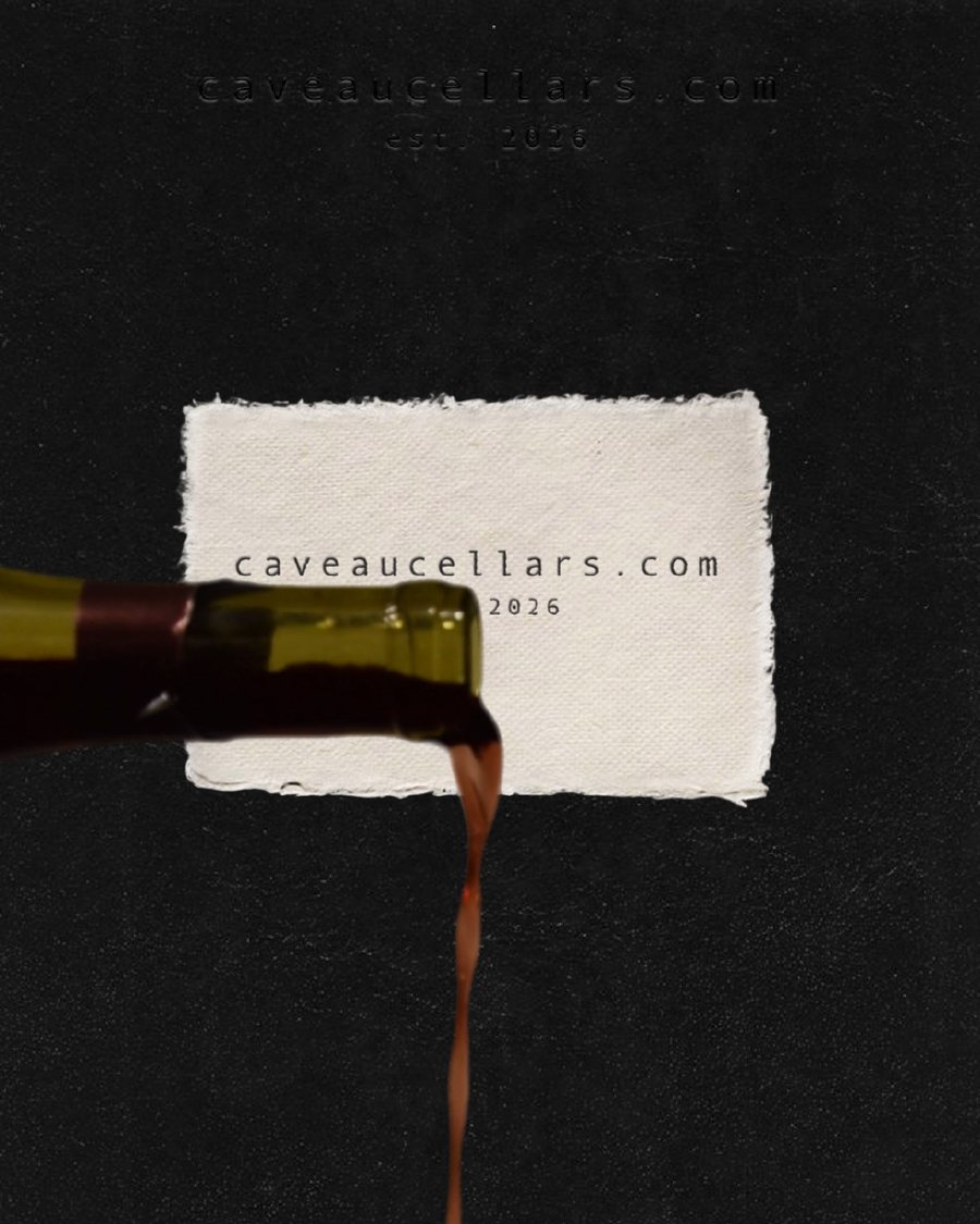 Red wine pouring from a bottle across a torn paper card reading caveaucellars.com